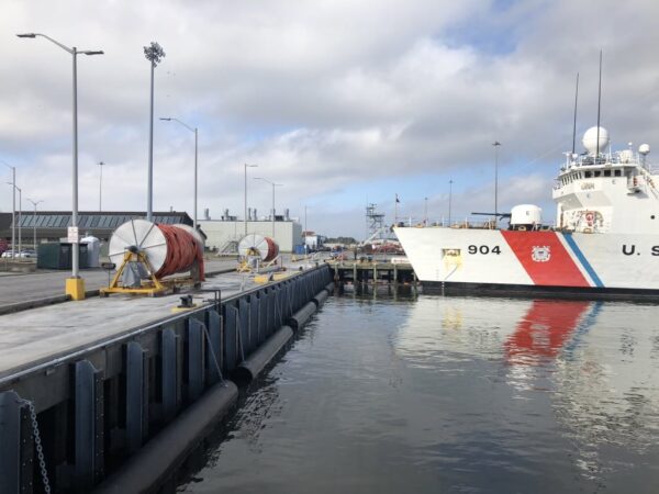 Marine construction project completed, new pier installation near a US Coast Guard Ship | Inland Construction & Engineering, Inc. Panama City, Florida providing construction, general contracting, marine construction, design & engineering, diving services, roofing, & bulding rehab.